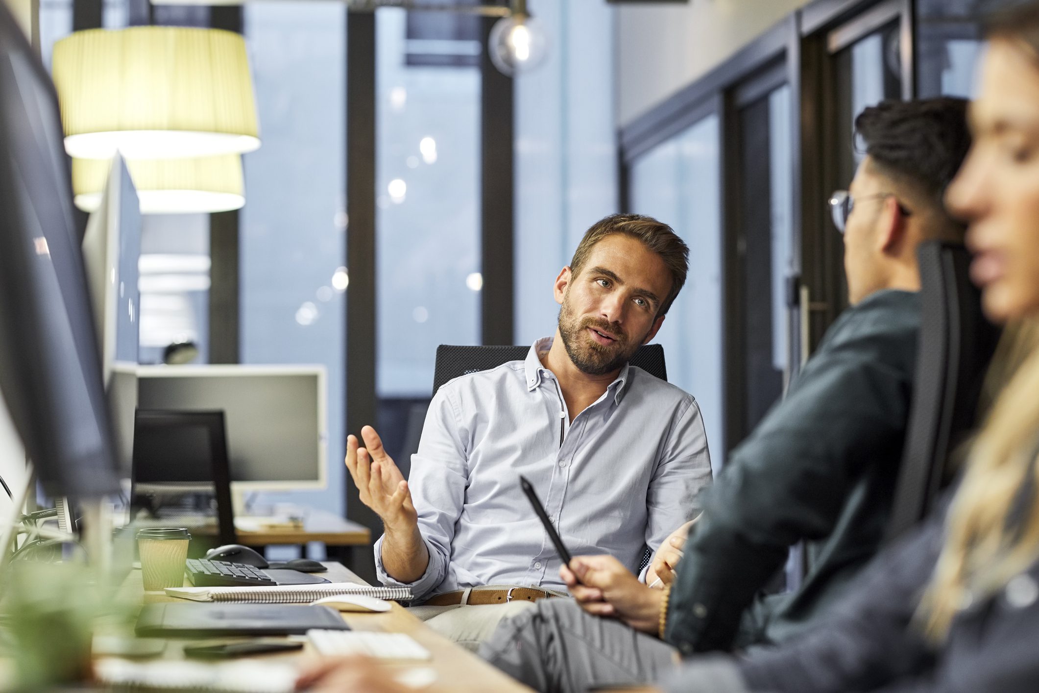 Man explaining with his colleagues at the office